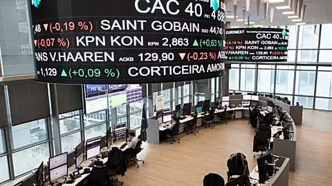 File - Analysts work at the Euronext headquarters in the business district la Defense, outside Paris, Tuesday, Jan. 10, 2017.