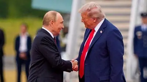 Putin and Trump shaking hands, with Air Force One in the background.