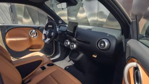 Smart #2 cabin with tan seats and door panels, a black dashboard, circular air vents and a central touchscreen.