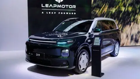 A dark-colored Leapmotor D19 SUV on display at the Paris Motor Show, viewed from the front three-quarter angle.