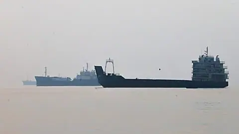 FILE. Commercial vessels appear anchored in the Strait of Hormuz off Bandar Abbas, Iran, 6 Oct. 2026