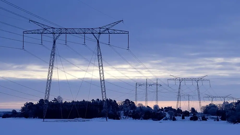 Power lines in winter landscape in the countryside north of Stockholm, Sweden, on Feb. 10, 2021.