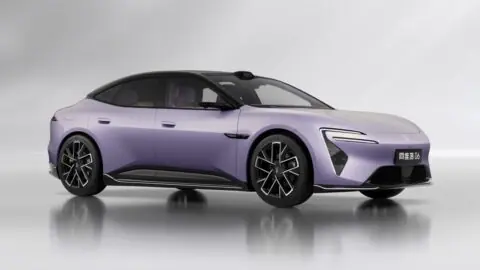 Purple Avatr 06 sedan with a contrasting black roof and dark alloy wheels against a gray studio background.