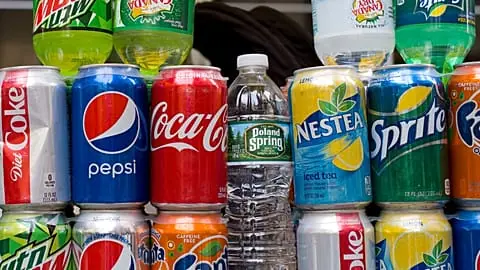 File - Cans of soda and bottled water are displayed on a food cart, Monday, 7 May 2018 in New York.
