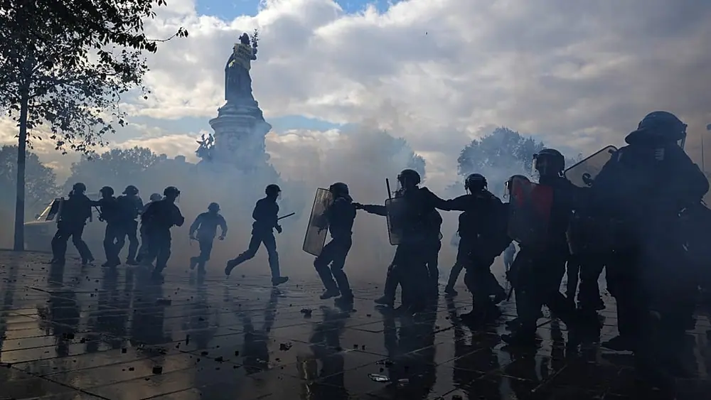 Police scuffle with protesters during a demonstration against rising living costs, joining students' grievances, in Paris, Saturday, Oct. 17, 2026.