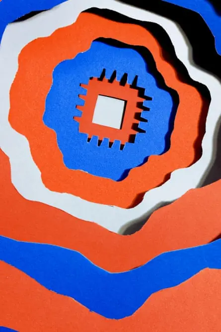 Red, white and blue layered paper cutout of a microchip