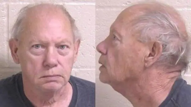 Police mugshots of Albert "Buddy" Zigler, a pale bald man, in a blue t-shirt