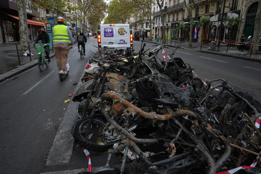 Charred bicycles the day after a quiet night under curfew in Paris, Tuesday 20 October 2026.