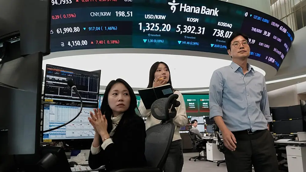 Currency traders work at the foreign exchange dealing room of the Hana Bank headquarters in Seoul, South Korea, Friday, 23 Oct. 2026.