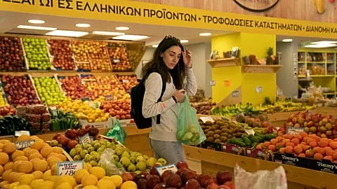 Personal trainer Antonia Kalantzi, 38, shops at a grocery store in Athens, Greece, on Feb. 16, 2022.