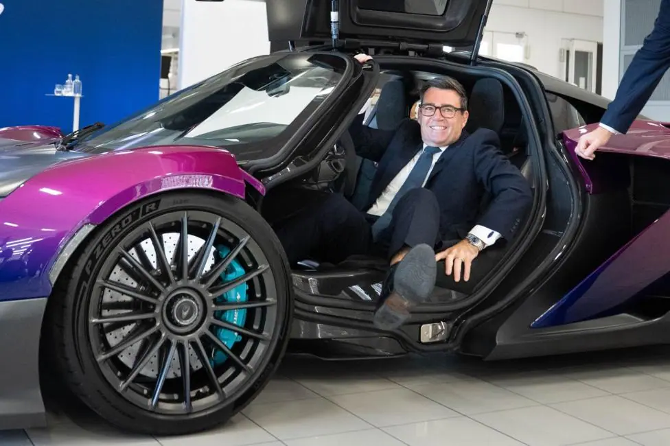 Prime Minister Andy Burnham gets out of a sports car at the McLaren Technology Centre in Woking, England