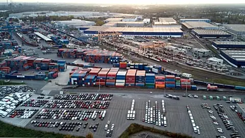 FILE. The sun sets behind the Duisport Logport logistics centre on the Rhine River in Duisburg, Germany, 28 October 2022