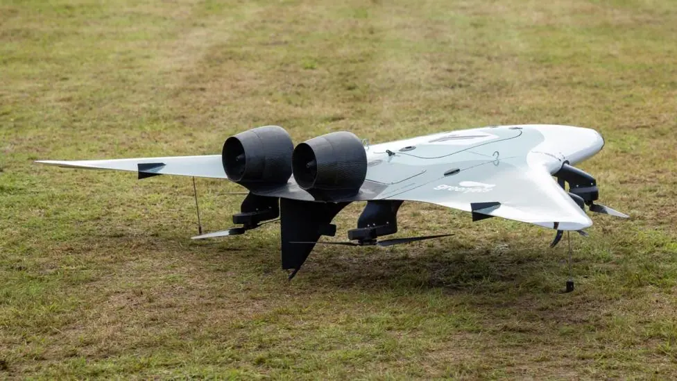 A greenjets drone has a blended wing and fuselage with two enclosed motors on the upper side. Underneath the wing are four propellers.